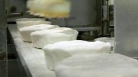 Anglia praca na produkcji masła w fabryce- Caerphilly, Wielka Brytania